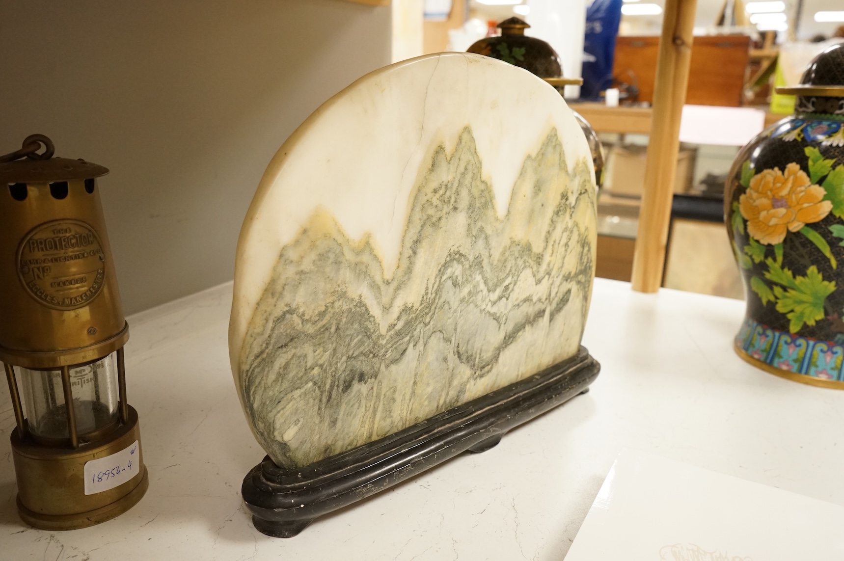 A Chinese dreamstone carving on stand, 38cm wide